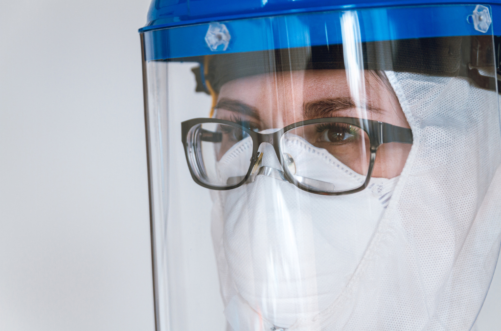 a doctor wearing a face shield and glasses