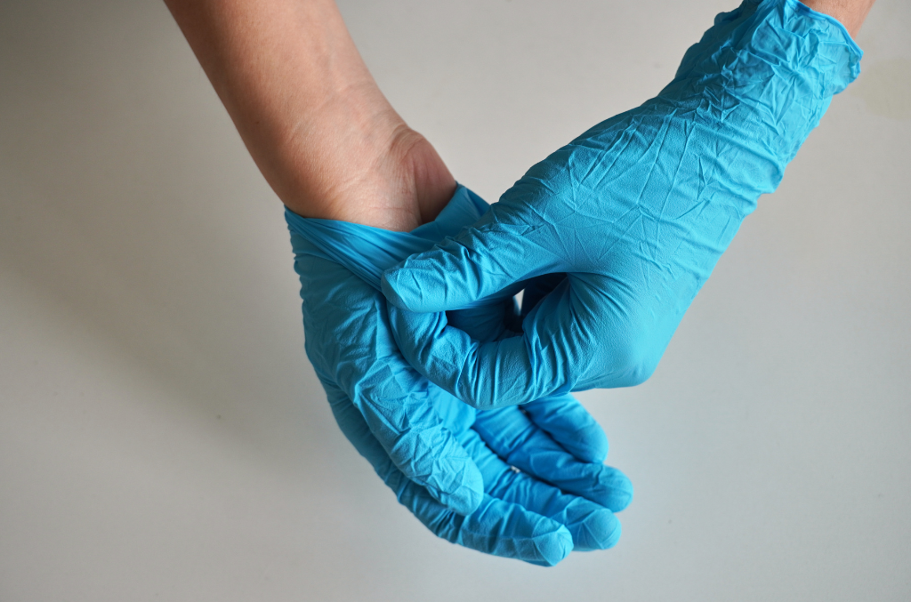 a doctor wearing blue disposable gloves