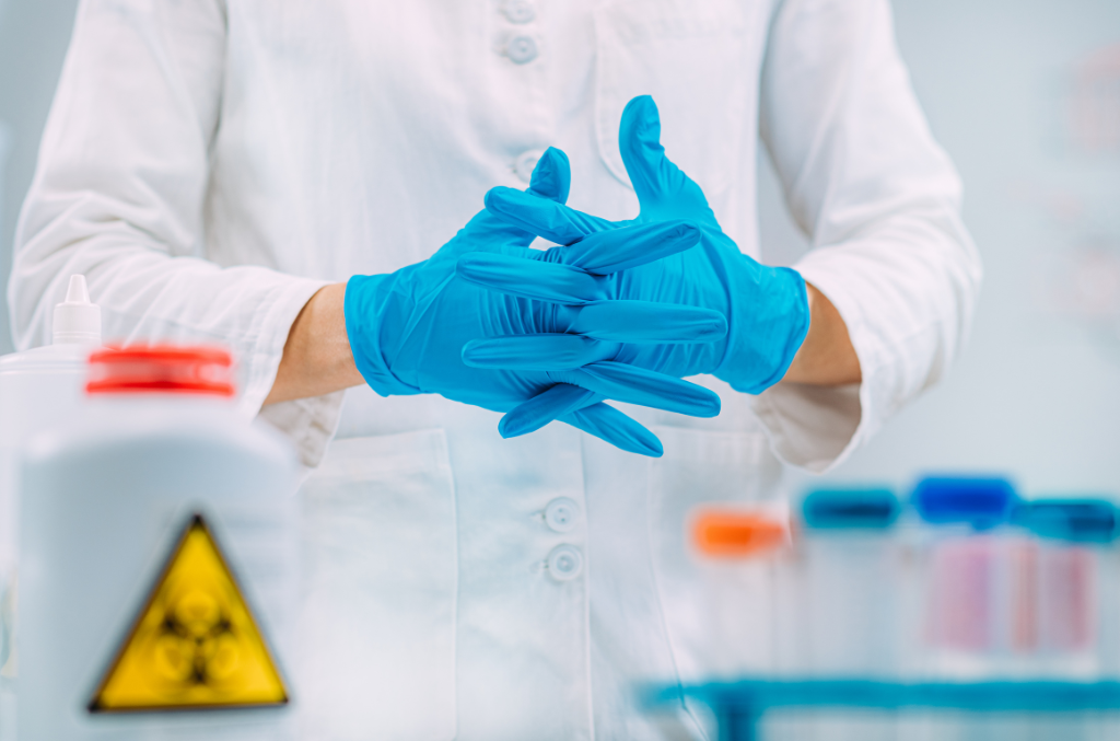 a scientist crossing his hands with blue Chemical Resistant Gloves